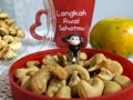 Mini figure standing in the middle of cashews Royalty Free Stock Photo