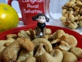 Mini figure standing in the middle of cashews Royalty Free Stock Photo