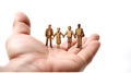 Mini figures family in hands on white background. Generative AI Royalty Free Stock Photo