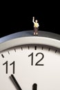 Mini figurine on a clock Royalty Free Stock Photo