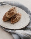 Mini french baguettes with flax seeds on a blue linen