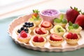 mini fruit tarts arranged on a pastel pink tray Royalty Free Stock Photo