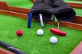 Mini-golf clubs and balls. Royalty Free Stock Photo