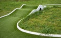 Mini golf lane with wavy hills and tunnel horizontal Royalty Free Stock Photo
