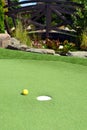 Mini golf course, yellow mini golf ball, closeup Royalty Free Stock Photo
