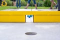 Mini golf course with a yellow obstacle gate Royalty Free Stock Photo