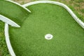 Mini golf lane with artificial turf and hole horizontal Royalty Free Stock Photo