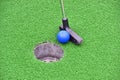 Mini golf leisure fun - club, ball and hole Royalty Free Stock Photo