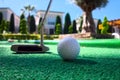 Mini golf scene with ball and club Royalty Free Stock Photo