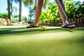 Mini Golf yellow ball with a bat at sunset Royalty Free Stock Photo