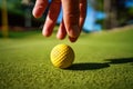 Mini Golf yellow ball on green grass at sunset Royalty Free Stock Photo