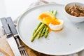 Mini grilled asparagus with egg and tuna. White background, side view. Royalty Free Stock Photo