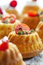 mini gugelhupf filled with cream cheese and ricotta garnished with tomato and marjoram.