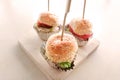 Mini hamburger snack is placed on a wooden Royalty Free Stock Photo