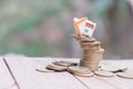 Mini house model and stack of coins. Business risk management. Property investment and house mortgage financial real estate