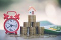 Mini house on stack of coins, Concept of Investment property, Investment risk and uncertainty in the real estate housing market Royalty Free Stock Photo