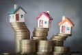 Mini house on stack of coins, Concept of Investment property, Investment risk and uncertainty in the real estate housing market Royalty Free Stock Photo