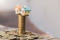 Mini house on stack of coins, Concept of Investment property, Investment risk and uncertainty in the real estate housing market Royalty Free Stock Photo