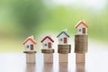 Mini house on stack of coins, Concept of Investment property, Investment risk and uncertainty in the real estate housing market Royalty Free Stock Photo