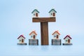 Mini house on stack of coins, Concept of Investment property, Investment risk and uncertainty in the real estate housing market Royalty Free Stock Photo