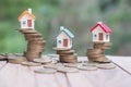 Mini house on stack of coins, Concept of Investment property, Investment risk and uncertainty in the real estate housing market Royalty Free Stock Photo