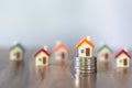 Mini house on stack of coins, Concept of Investment property, Investment risk and uncertainty in the real estate housing market Royalty Free Stock Photo