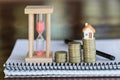 Mini house on stack of coins,Money and house, Mortgage, Savings money for buy house and loan to business investment for real Royalty Free Stock Photo