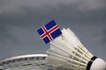 Mini Iceland flag stick on the white shuttlecock on the badminton racket with grey background Royalty Free Stock Photo