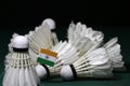 Mini India flag stick on the heap of used shuttlecocks on green floor of Badminton court
