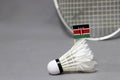 Mini Kenya flag stick on the white shuttlecock on the grey background and out focus badminton racket