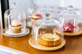 Mini Key Lime Pie topping with slice of lime in wooden plate and cover with glass cloche