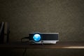 mini led projector on wood table in a room projector home theater concept. Royalty Free Stock Photo