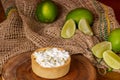 mini lemon pie topped with whipped cream and lemons in the background Royalty Free Stock Photo