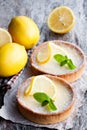 Mini lemon tarts on wooden table Royalty Free Stock Photo