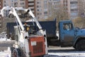 The mini-loader removes snow, clearing the city .Cleaning of the territory by public utilities in winter Royalty Free Stock Photo