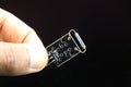 Mini magnetic reed switch module for minor project held in hand on black background, sensor for arduino, raspberry pi and other