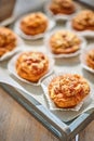 Mini meat pies from flaky dough on a tray over wooden background. Royalty Free Stock Photo