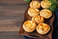 Mini meat pies from flaky dough on a vintage tray over wooden ba Royalty Free Stock Photo