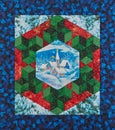 Mini medallion quilt the snowed village surrounded by a stylized Christmas wreath