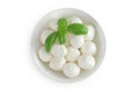 Mini mozzarella balls with basil in a ceramic bowl isolated on white background. Top view. Flat lay. Royalty Free Stock Photo