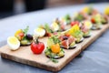 mini nicoise salads served as appetizers on a slate tray