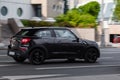 Mini Paceman is a subcompact, three door crossover SUV based on the crossover Mini Countryman. Black car in motion on the urban