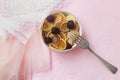 Mini pancakes with blackberry white dishes on a pink table. Lovely breakfast, morning light.