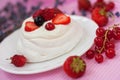 Mini Pavlova Cake dessert with fresh strawberries, black and red currants. Summer dessert with berries. French cake