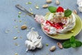 Mini Pavlova cakes with strawberry sauce, pistachios and fresh berries Royalty Free Stock Photo