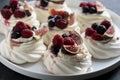 Mini Pavlova meringue cakes decorated with berries and figs Royalty Free Stock Photo