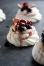 Mini Pavlova meringue cakes decorated with berries and figs Royalty Free Stock Photo