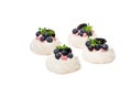 Mini Pavlova meringue nests with berries and thyme isolated on