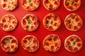 Mini pepperoni pizzas on red background. Top view, flatlay composition. Generative Ai Royalty Free Stock Photo