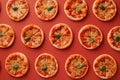Mini pepperoni pizzas on red background. Top view, flatlay composition. Generative Ai Royalty Free Stock Photo